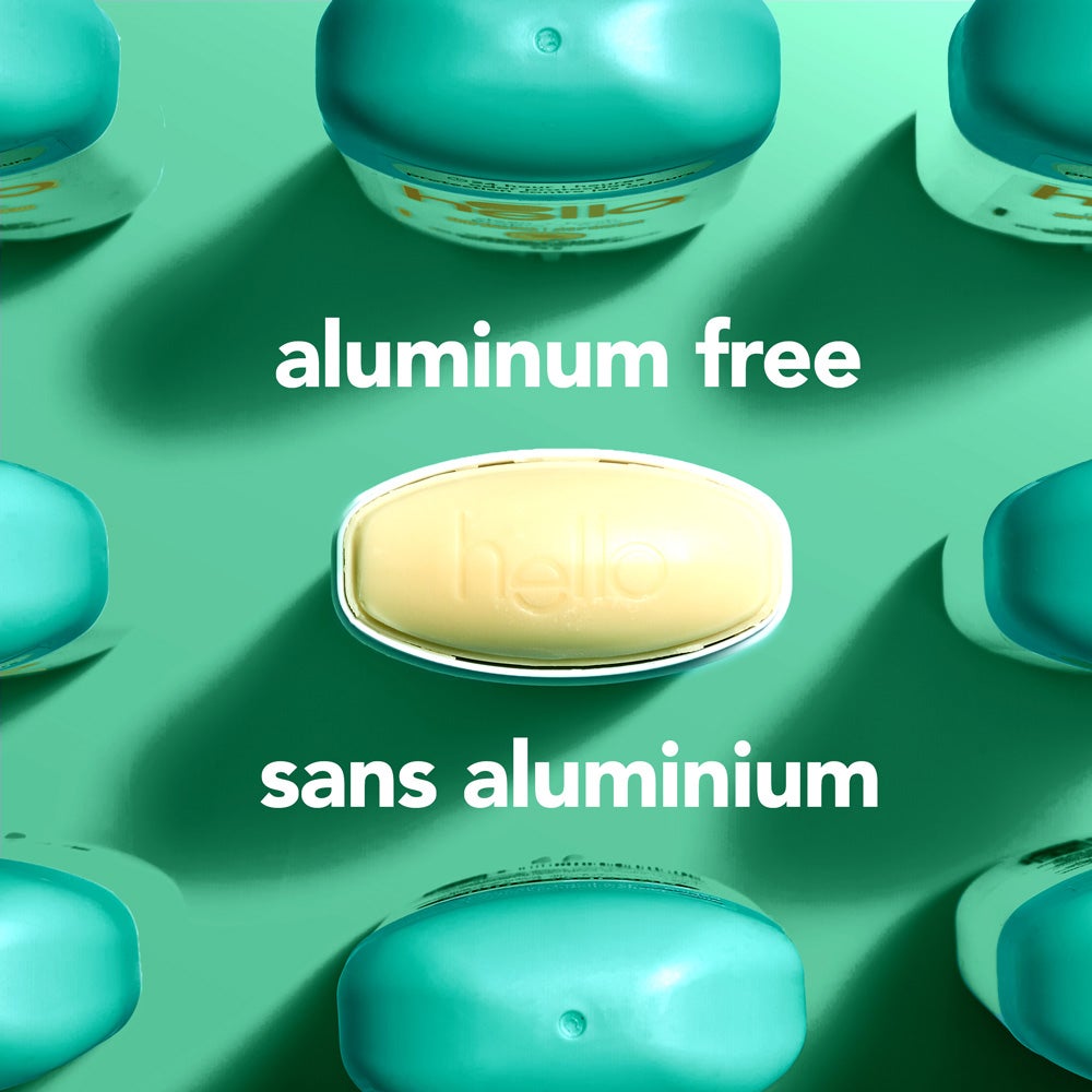 A top-down view of several green deodorant containers arranged around a central oval container embossed with the word "hello." The image includes the text "aluminum free."
