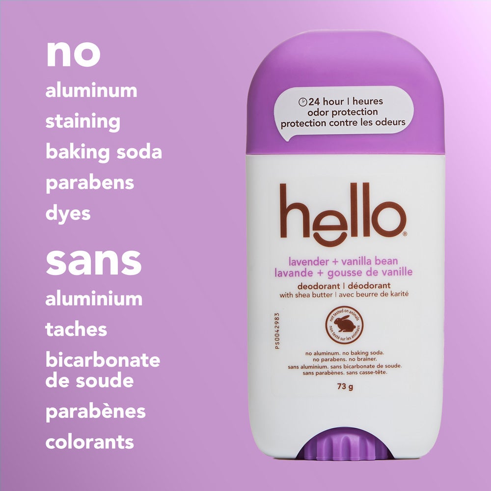A close-up of a hello Lavender Vanilla Bean deodorant stick with a little purple cap, standing upright on a light purple background. The image features text listing product attributes: "no aluminum, staining, baking soda, parabens, dyes."