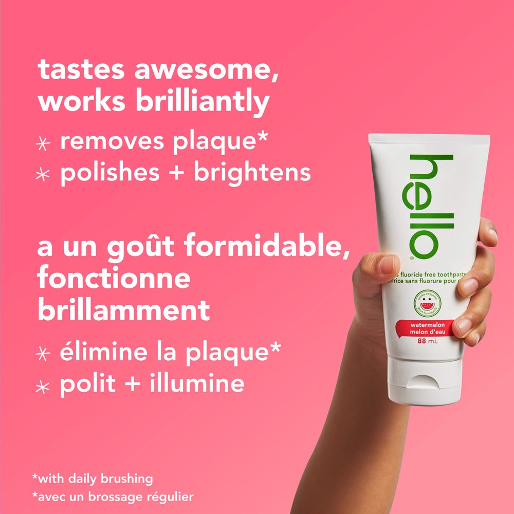 A tube of Hello brand watermelon fluoride-free toothpaste is surrounded by slices of fresh watermelon against a pink background. The text above the product reads, &quot;watermelon fluoride free toothpaste.&quot;