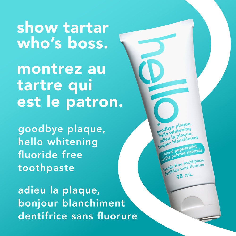 Un tube de dentifrice sans fluorure hello adieu la plaque bonjour blanchiment est placé dans un angle sur un fond bleu vif. Le texte en gros caractères indique « montrez au tartre qui commande » en anglais et en français. Un texte plus petit indique, « goodbye plaque, hello whitening, fluoride free toothpaste » et sa traduction française (« adieu la plaque, bonjour blanchiment, dentifrice sans fluorure »).