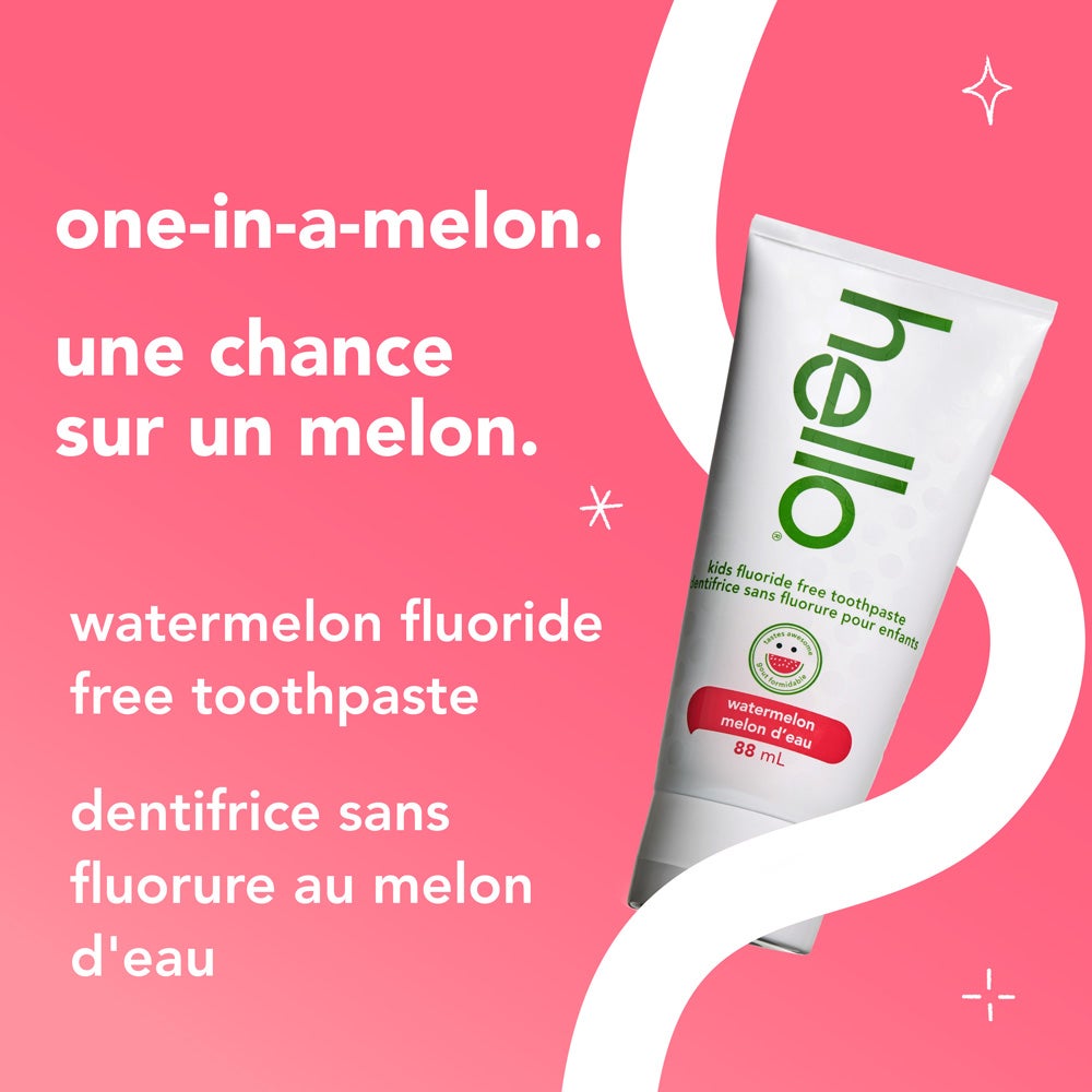 A tube of hello kids watermelon fluoride free toothpaste is set against a pink and white background with curved accents. The text reads, &quot;one-in-a-melon. watermelon fluoride free toothpaste.&quot;